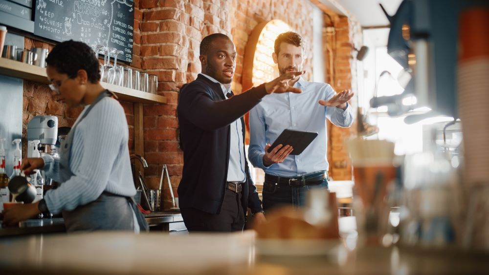 Coffee Shop Owners Meeting Behind the Counter